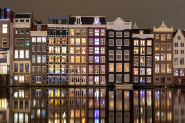 Night view of iconic ancient medieval buildings in the Old Town of Amsterdam, Netherlands