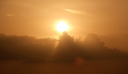 Bright colorful sunset sky with rays of setting sun and vivid dark clouds