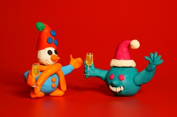 A figure of a virus and a snowman with a glass of champagne in his hand. Fairy-tale characters on a...