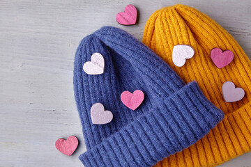 Love and romance concept. Valentine's Day. Two knitted blue and yellow hats