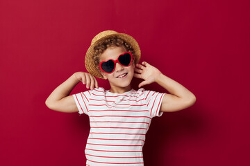 little boy wearing sunglasses and hat posing fashion childrens style