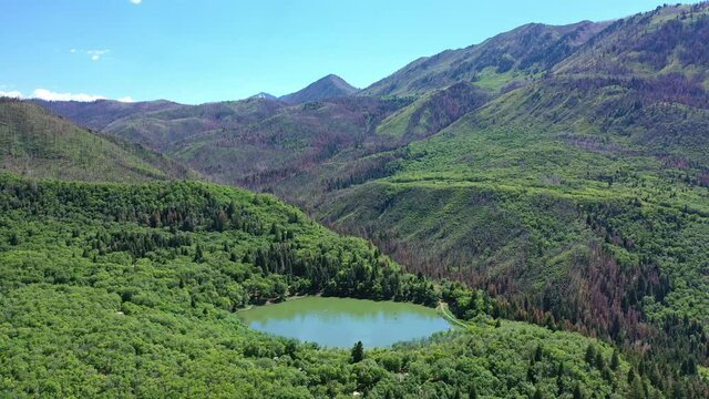 Aerial shot Maple Lake on Nebo Loop up Payson Canyon above Utah Valley mountains