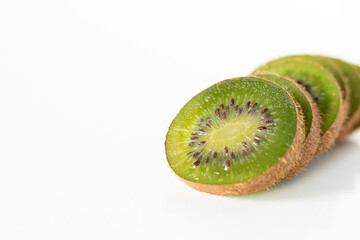Green kiwi fruit sliced and isolated on white background with copy space. A close-up of fresh,...