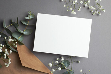 Wedding invitation or greeting card mockup with envelope, eucalyptus and gypsophila plants...