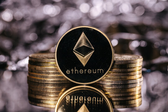 Ethereum cryptocurrency, physical coin in front of an abstract background.