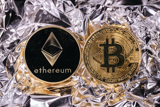 Ethereum and bitcoin cryptocurrency, physical coins in front of an abstract background.