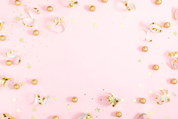 Pink festive background with gold confetti, sparkles and stars. Party background. Flat lay, top view, copy space