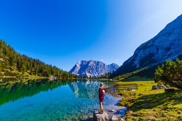 woman enjoying beauty of nature looking at mountain. Adventure travel, Europe. Woman stands on...