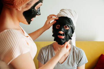 Woman apply paper black mask skin care. cosmetic procedures, mask for skin care, woman young, spa...