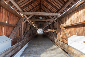 Fototapeta na wymiar A view inside the Arthur Smith Covered Bridge in northwestern Massachusetts to see the framing and symmetry 