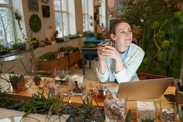 Young woman resting in the studio with laptop