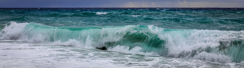 Waves at the beach on cloudy and stormy weather