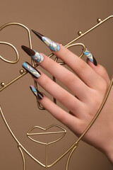 Creative design of nails on female hands. Art manicure.
