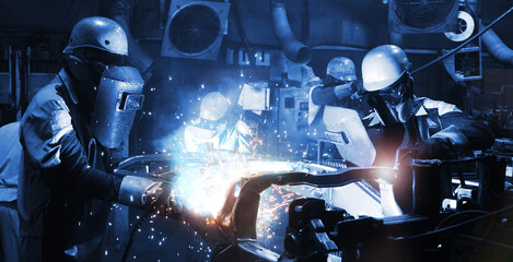 welder Industrial automotive part in factory, worker with protective mask welding metal (welding,...