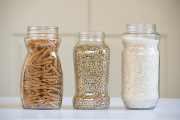 Front view of three glass jars with foodstuffs
