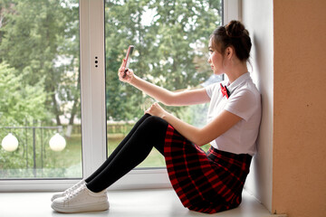 high school student is sitting on the windowsill. Anime style