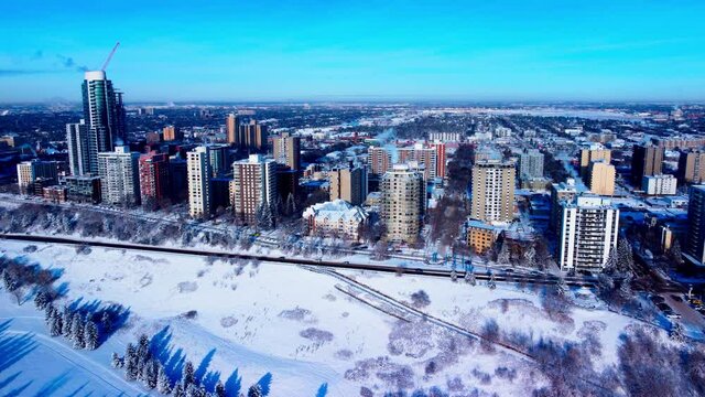 VIP Residential High Rise Luxury Buildings at the Victoria Park Valley edge sunny winter afternoon clear blue sky aerial drone flyover downtown road to the West Side Real Estate posh homes of desire
