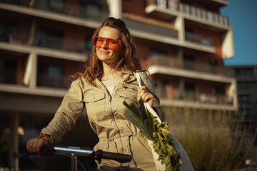 Fototapeta na wymiar smiling female against residential building outdoors in city