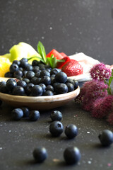 blueberries, strawberries and other variety of fruits on dark background