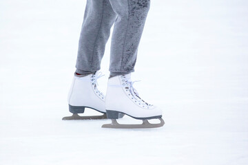 feet on skates on an ice rink. winter sport and recreation