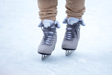 feet on skates on an ice rink. winter sport and recreation