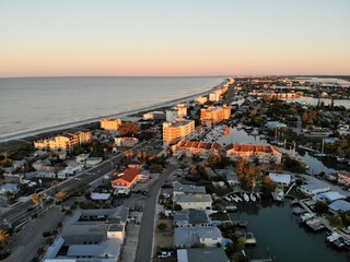 The aerial view of the beach and waterfront resorts hotel during sunrise near Madeira Beach, Florida, U.S