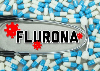 scattered pills and a stethoscope with the word FLURONA. new variant