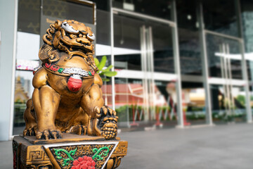 Chinese golden god lion statue is the Asia zen structure ornament emperor in front of the door to...
