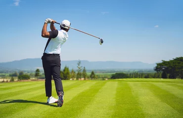 Poster Im Rahmen Asian man golfing on the course. In summer © torwaiphoto