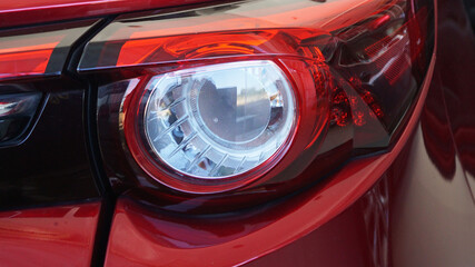 Red sports car tail lights Modern design provides light for safe driving, preventing accidents in...