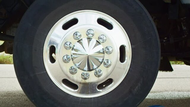 Tight shot of the wheel of a truck slowly turning