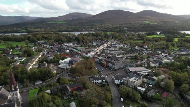 Aerial View of Downtown Kenmare, Ireland. Idyllic Town on Sunny Evening Streets, Holy Cross Catholic Church and Bay in Background, Drone Shot