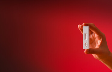 COVID-19 pandemic. Concept photo of a woman hand showing the result of a self made speed antigen test to confirm coronavirus infection. Negative for covid.