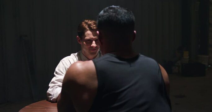 Business man accepts arm wrestling match with a smirk