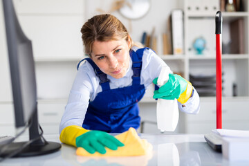 adult female cleaner with cleaning supplies washing in cabinet. High quality photo