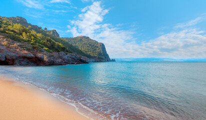 Cleopatra sand beach among rocks on evening sunset - Alanya, Turkey               © muratart