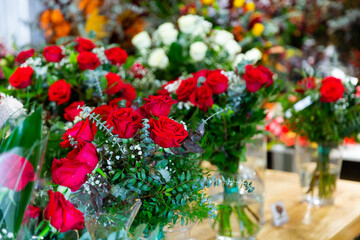 Fototapeta na wymiar Handcrafted bouquets of flowers placed in salesroom of florist shop.