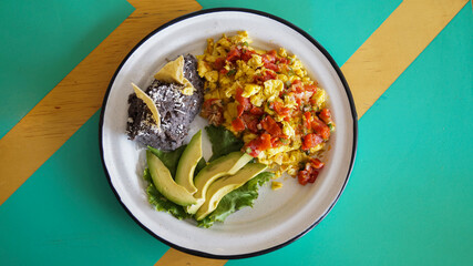 Mexican scrambled egg with avocado and beans