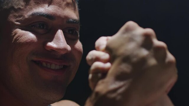 Tight shot of a body builder winning an arm wrestling match