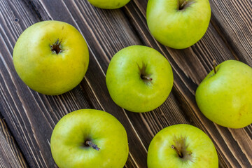 Green apples on wooden background