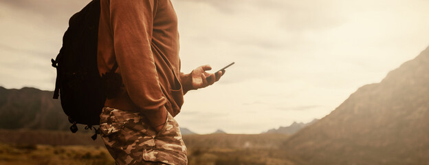 Person using mobile phone in the mountains - Powered by Adobe