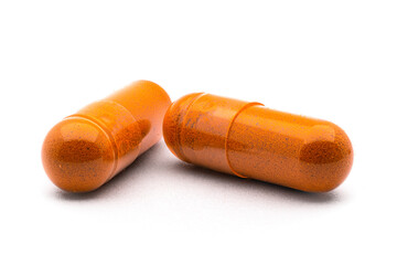 turmeric capsule, curcuma powder and tumeric rhizome,(Curcuma longa), isolated on white background. curcumina