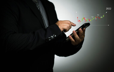 Businessman conducting online transactions via online networks, mobile stock exchange, mobile...