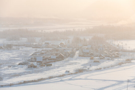 View from the hill to the Yakutsk city in the fog on a cold winter day
