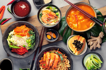 Asian dishes variety on gray background.