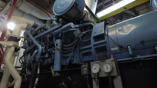 Auxiliary diesel generator in engine room of ship
