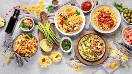 Pasta assortment on gray background.