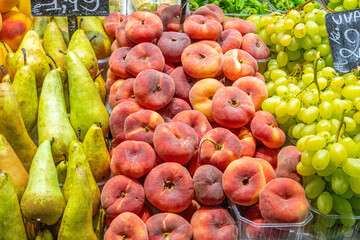 Peaches, pears and grapes for sale at a market