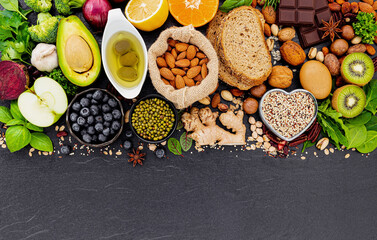 Ingredients for the healthy foods selection. The concept of healthy food set up on dark stone background.