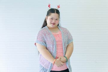 Portrait studio shot of Asian young cute chubby female down syndrome autistic model wear red dear...